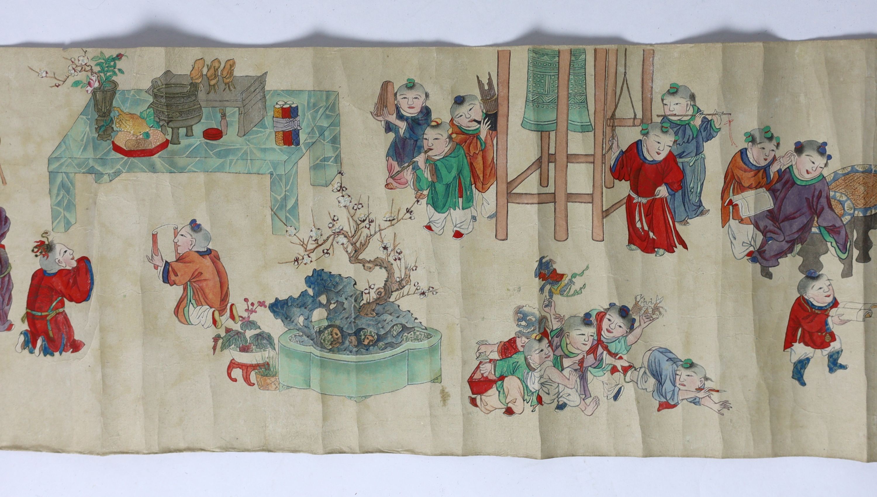 A Chinese handscroll painting on paper of ‘Hundred boys’ in a garden, late Qing dynasty, image 570cm x 26cm